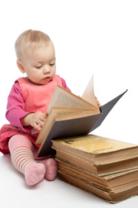 Baby girl reading book